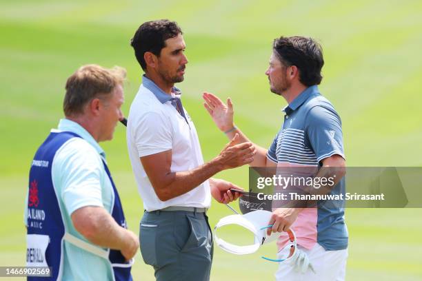 Rafa Cabrera Bello of Spain interacts with Ewen Ferguson of Scotland as they finish their round on the ninth green during Day Two of the Thailand...