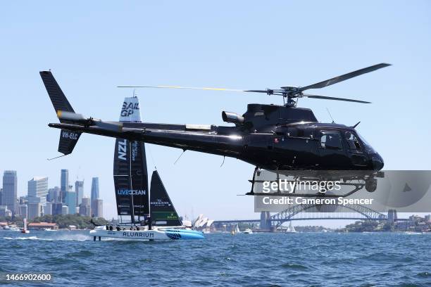 New Zealand SailGP team train as a broadcast helicopter passes during an official practice session ahead of SailGP Australia on Sydney Harbour on...