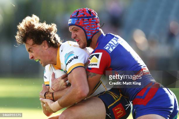 Clinton Gutherson of the Eels is tackled by Kalyn Ponga of the Knights during the NRL Trial Match between the Newcastle Knights and the Parramatta...