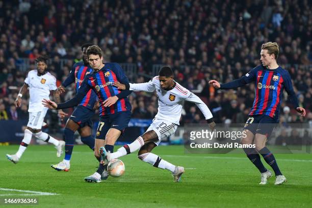 Marcus Rashford of Manchester United competes for the ball with Marcos Alonso of FC Barcelona during the UEFA Europa League knockout round play-off...