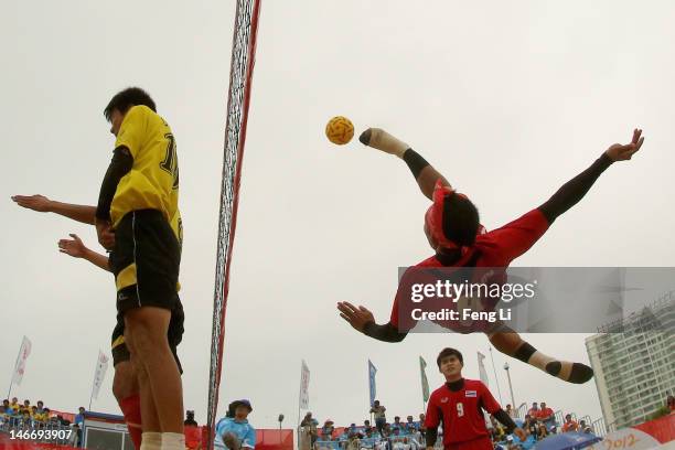 Komkid Suapimpa of Thailand kicks over the net against Jin Jie of China during the Beach Sepaktakraw Men's Regu Final between China and Thailand on...