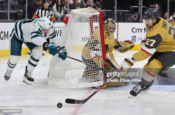 Evgeny Svechnikov of the San Jose Sharks knocks the goal off of its Marsh pegs as he tries to score against Adin Hill and Shea Theodore of the Vegas...