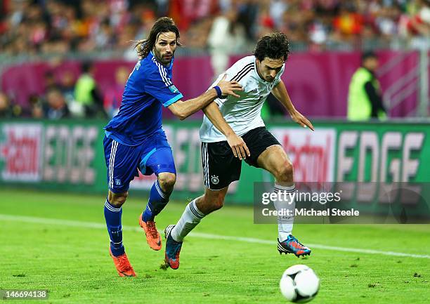 Mats Hummels of Germany and Giorgos Samaras of Greece compete for the ball during the UEFA EURO 2012 quarter final match between Germany and Greece...