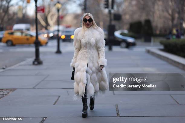 Corina Mihaila Larpin seen wearing Linda Fargo black sunglasses, Alexander McQueen white fur long coat, black leather leggings, YSL black leather...