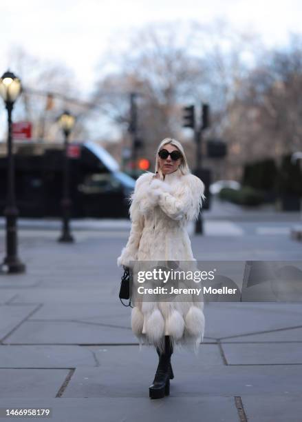 Corina Mihaila Larpin seen wearing Linda Fargo black sunglasses, Alexander McQueen white fur long coat, black leather leggings, YSL black leather...