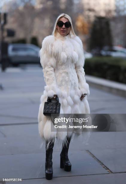 Corina Mihaila Larpin seen wearing Linda Fargo black sunglasses, Alexander McQueen white fur long coat, black leather leggings, YSL black leather...