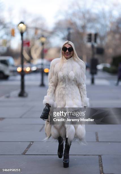 Corina Mihaila Larpin seen wearing Linda Fargo black sunglasses, Alexander McQueen white fur long coat, black leather leggings, YSL black leather...