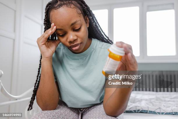 young woman feels drug side effects - drug side effects stock pictures, royalty-free photos & images