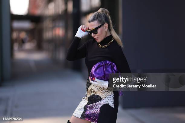 Olga Ferrara seen wearing black sunglasses, gold statement chain necklace, gold earrings, Fallonandava black turtleneck, Seymoure white leather pearl...