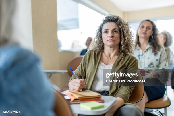 college student paying attention in class - real people stockfoto's en -beelden