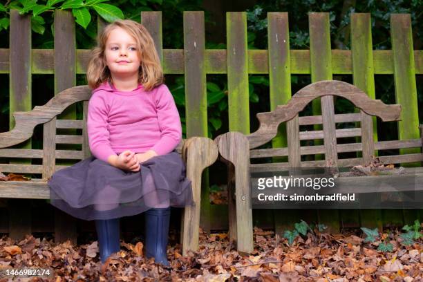 little girl on the bench - simonbradfield stock pictures, royalty-free photos & images