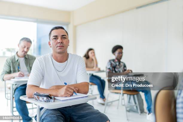 portrait of man with leg prosthesis in classroom - financial literacy stock pictures, royalty-free photos & images