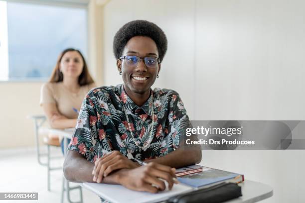 portrait of smiling young black man in college - roupa descontraída stock pictures, royalty-free photos & images