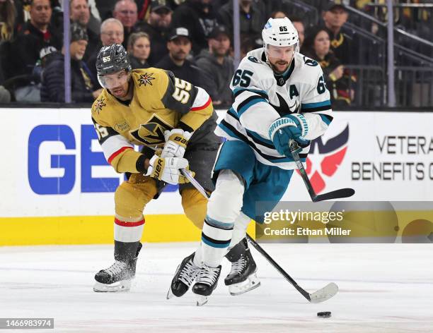 Erik Karlsson of the San Jose Sharks skates with the puck against Keegan Kolesar of the Vegas Golden Knights in the third period of their game at...