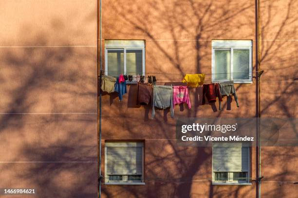 clothes hanging in the neighborhood - varal de roupa imagens e fotografias de stock