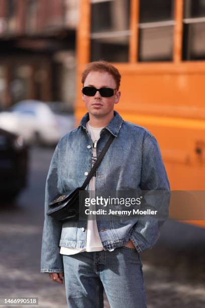 Erik Scholz seen wearing Prada Symbole black sunglasses, Wrstbhvr white cotton printed t-shirt, Zara blue denim two-piece with a long jeans pants and...