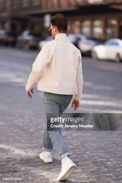 Gregor Wolski seen wearing beige sunglasses, Ralph Lauren creme white turtleneck sweater, Levi’s blue denim jeans pants, Bottega Veneta creme white...
