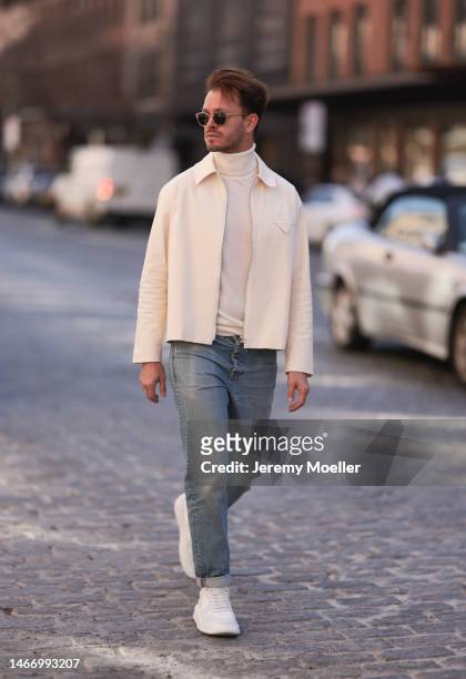 Gregor Wolski seen wearing beige sunglasses, Ralph Lauren creme white turtleneck sweater, Levi’s blue denim jeans pants, Bottega Veneta creme white...