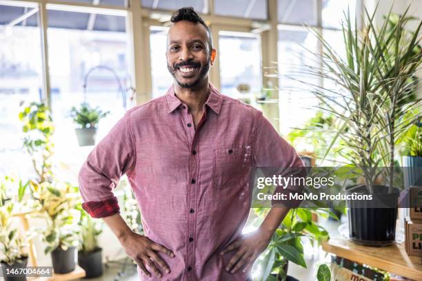 portrait of proud male flower shop owner - hand on hip men pink stock pictures, royalty-free photos & images