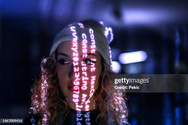 computer code projected on young woman's face - projectieapparatuur stockfoto's en -beelden