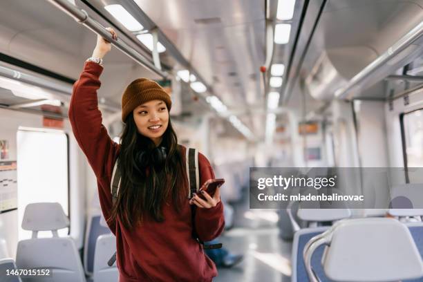 beautiful woman using phone in train - tourist talking on the phone stock pictures, royalty-free photos & images