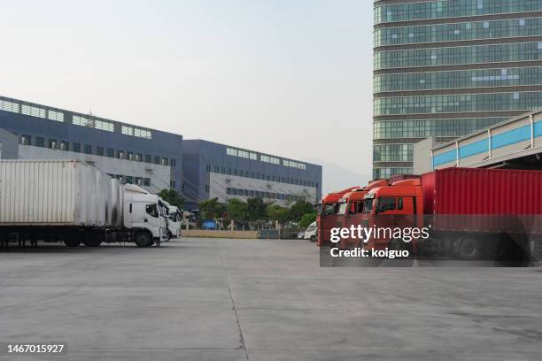 trucks parked in logistics park - parking space stock-fotos und bilder