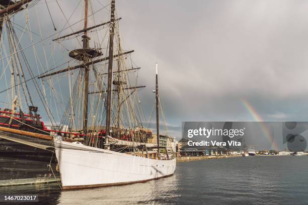 saint malo port with picturesque rainbow and white pirate sailboat - pirate flag stock pictures, royalty-free photos & images