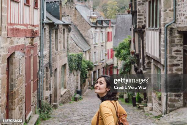 caucasian young woman with backpack traveling around france in autumn - bretagne stock pictures, royalty-free photos & images