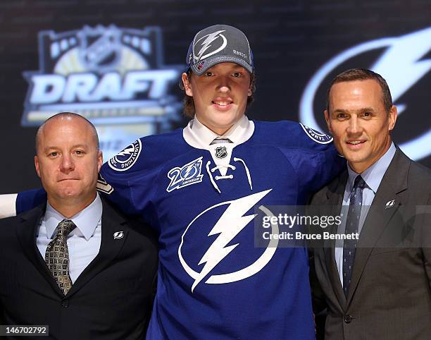 Andrei Vasilevski , 19th overall pick by the Tampa Bay Lightning, poses on stage with general manager Steve Yzerman and team representatives during...