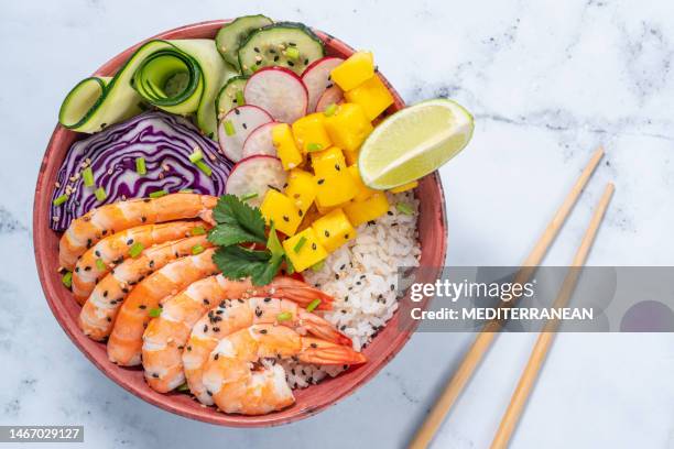 shrimp poke bowl on white marble with mango, avocado, radish, carrot, cucumber - shrimp edamame stock pictures, royalty-free photos & images