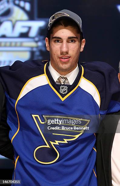Jordan Schmaltz, 25th overall pick by the St. Louis Blues, poses on stage during Round One of the 2012 NHL Entry Draft at Consol Energy Center on...