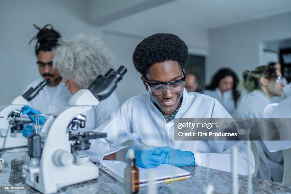 Taking Lab Notes College Student Taking Notes In The Lab High-Res Stock Photo - Getty Images