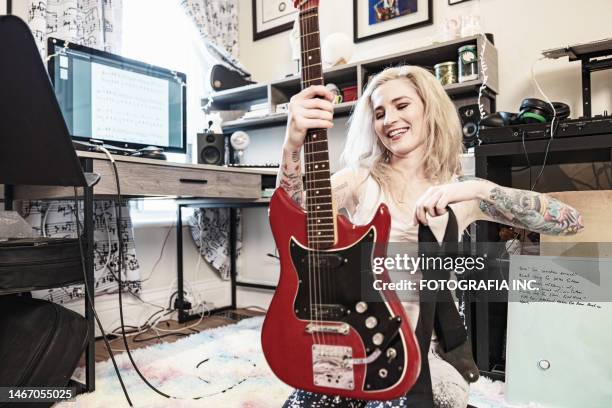 female musician practising at home - woman electric guitar stock pictures, royalty-free photos & images