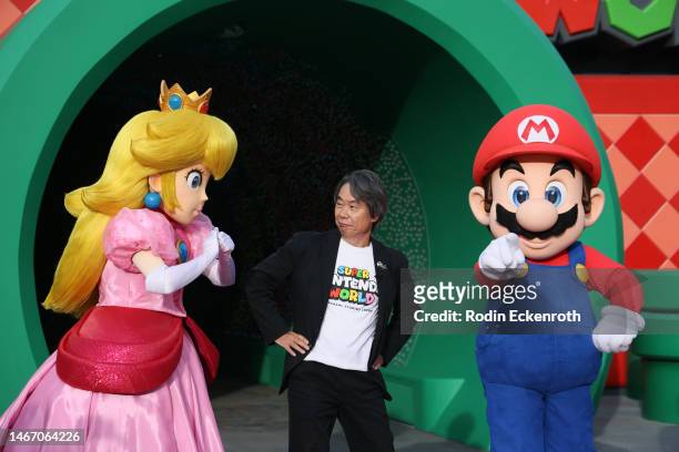 Representative Director and Fellow, Nintendo Co. Ltd. Shigeru Miyamoto poses for portrait with Princess Peach and Mario characters during the Grand...