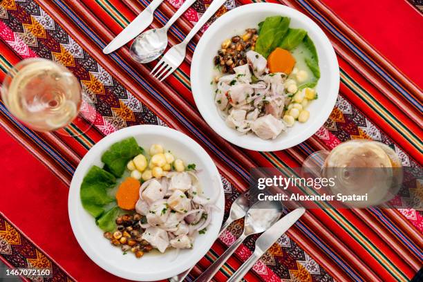 fresh ceviche with raw fish served at peruvian restaurant, high angle view - peruvian culture fotografías e imágenes de stock