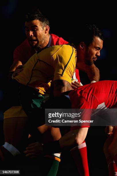 Digby Ioane of the Wallabies is tackled during the International Rugby Test match between the Australian Wallabies and Wales at Allianz Stadium on...