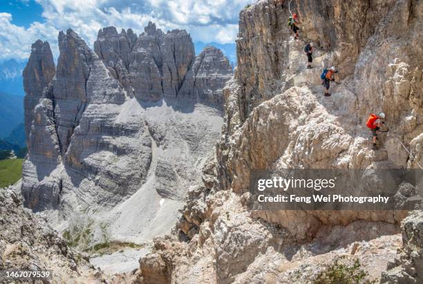 group of hikers climbing on via ferrata, tre cime di lavaredo circuit hike, dolomites, south tyrol, italy - off the beaten path stock pictures, royalty-free photos & images