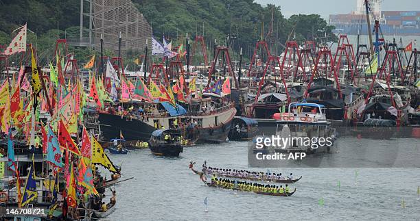 Participants take part during the dragon boat racing in the Aberdeen typhoon shelter in Hong Kong on June 23, 2012. According to legend national hero...