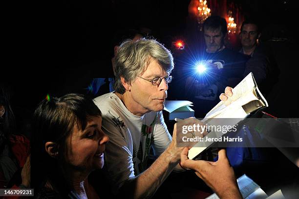 Author Stephen King signs autographs for fans prior to performing with the Rock Bottom Remainders at El Rey Theatre on June 22, 2012 in Los Angeles,...