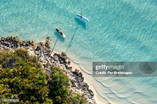 aerial view  of two women paddle boarding exuma bahamas - bahamas aerial bildbanksfoton och bilder