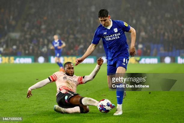 Callum O'Dowda of Cardiff City FC competes for the ball with Junior Hoilett of Reading FC during the Sky Bet Championship between Cardiff City and...