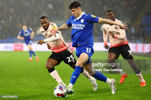 Callum O'Dowda of Cardiff City FC being followed by Junior Hoilett of Reading FC during the Sky Bet Championship between Cardiff City and Reading at...