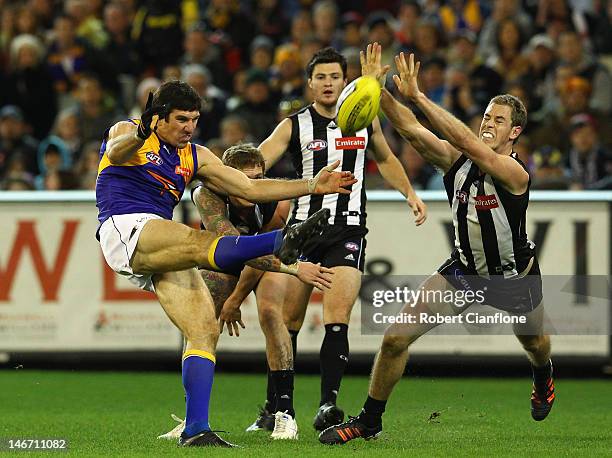 Quinten Lynch of the Eagles has his kick smothered by Nick Maxwell of the Magpies during the round 13 AFL match between the Collingwood Magpies and...