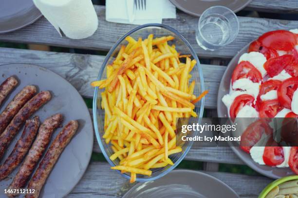 barbecue party and catering outside on a summer evening at sunset - fast food french fries stock pictures, royalty-free photos & images