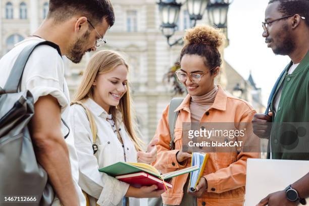group of university students hanging out after class - international students stock pictures, royalty-free photos & images
