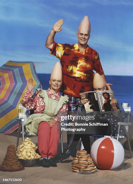 The Coneheads family sit on a beach with cone-shaped piles of food in Los Angeles in 1993.