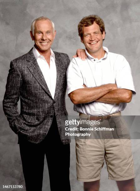 Legendary late night hosts Johnny Carson and David Letterman smile at camera in Los Angeles in 1988.