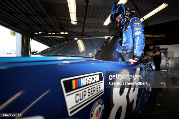 Jimmie Johnson, driver of the Carvana Chevrolet, enters in his car in the garage area during practice for the NASCAR Cup Series 65th Annual Daytona...