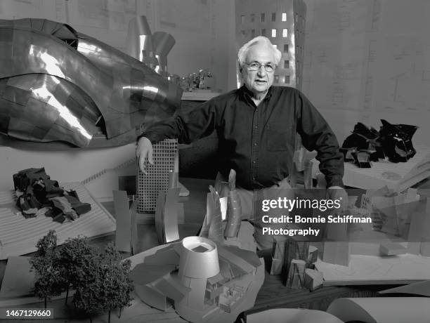 Architect Frank Gehry poses with miniatures of his designs in Los Angeles in 1989.