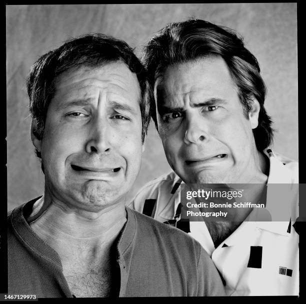 Chevy Chase and Dan Aykroyd comically grimace at the camera in Los Angeles in February of 1986 in Los Angeles.